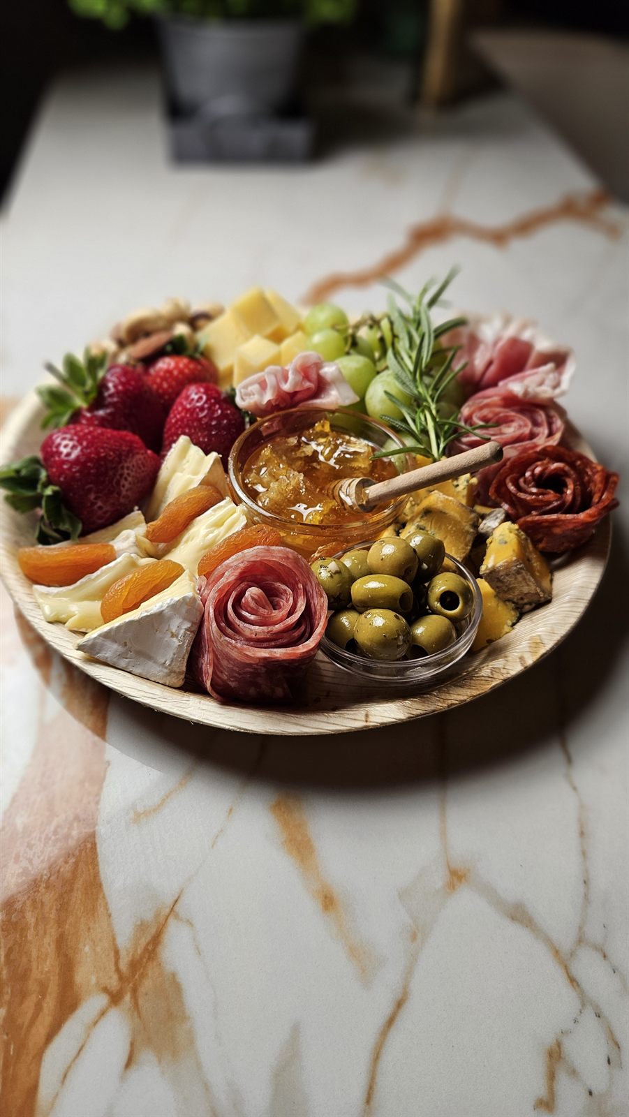 A generous Social Nibble grazing board styled with charcuterie roses, cheeses, honey and fruit